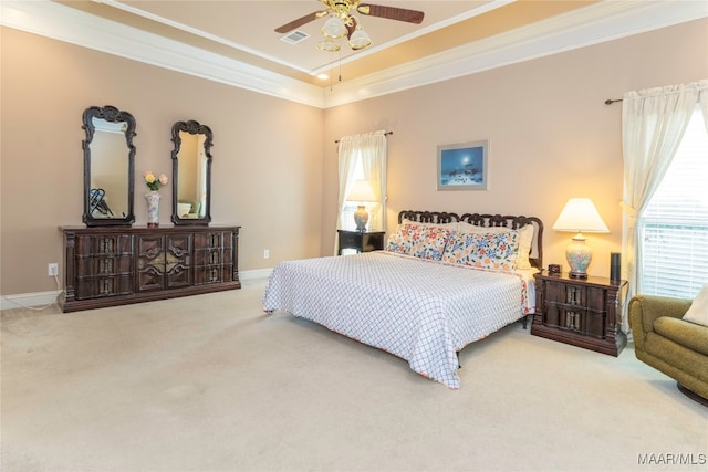 carpeted bedroom featuring a raised ceiling, ceiling fan, and crown molding