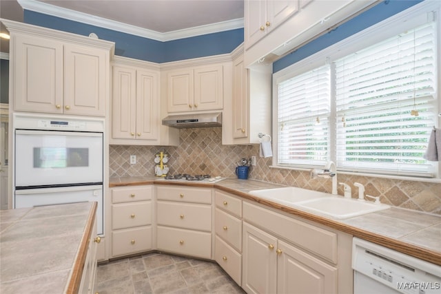 kitchen featuring tile countertops, white appliances, sink, and ornamental molding