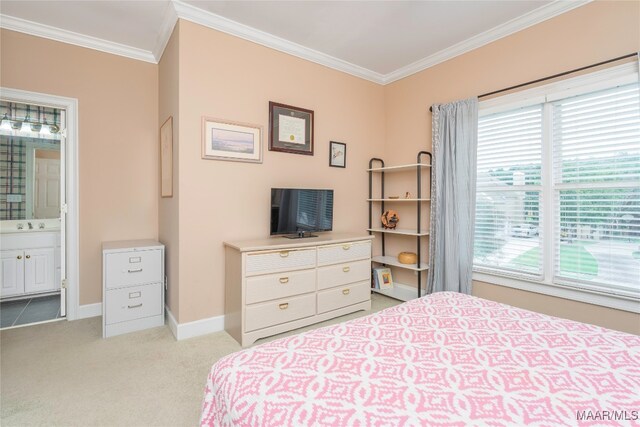 bedroom featuring ensuite bath, crown molding, and light colored carpet