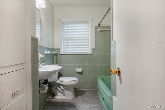 bathroom featuring shower / washtub combination, tile walls, tile patterned flooring, and toilet