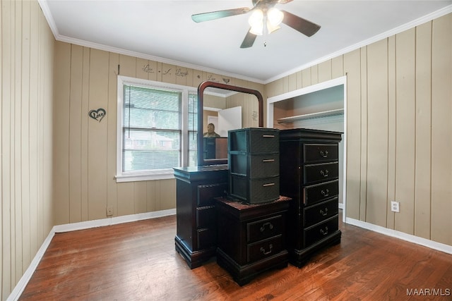 office with wooden walls, ceiling fan, dark hardwood / wood-style floors, and crown molding