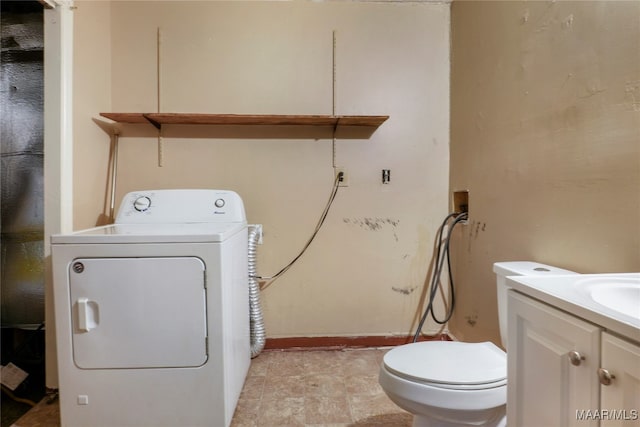 interior space with washer / clothes dryer, vanity, and toilet