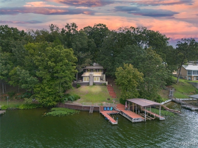 dock area with a yard and a water view