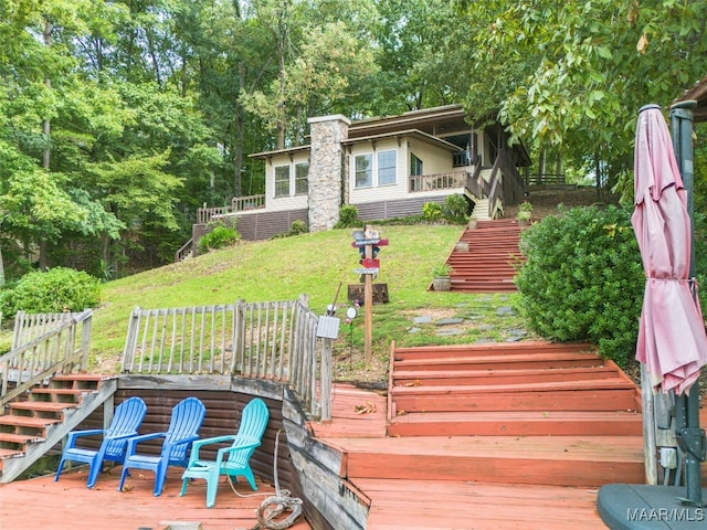 wooden terrace with a lawn