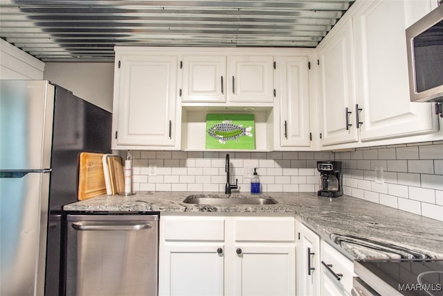 kitchen with white cabinetry, appliances with stainless steel finishes, and sink