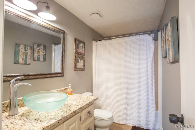 full bathroom with shower / bath combo, a textured ceiling, tile patterned floors, vanity, and toilet