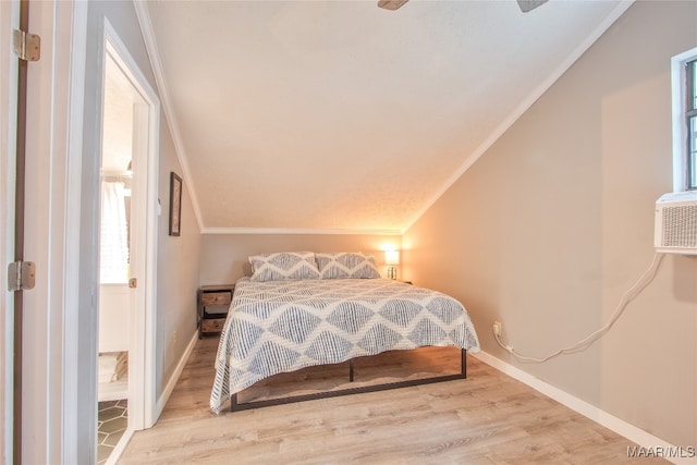 bedroom with lofted ceiling, ornamental molding, and hardwood / wood-style floors