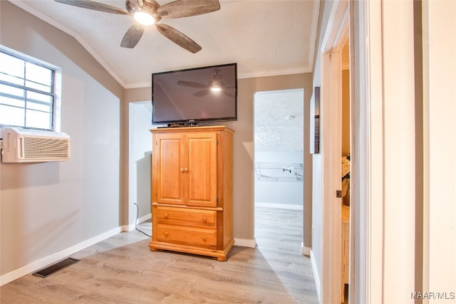 interior space with ornamental molding, light hardwood / wood-style floors, ceiling fan, and a textured ceiling