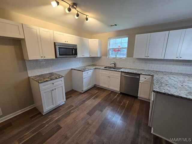 1780 Fitzpatrick Rd, Wetumpka, AL 36092 - kitchen with visible vents, appliances with stainless steel finishes, dark wood-type flooring, a sink, and light stone counters
