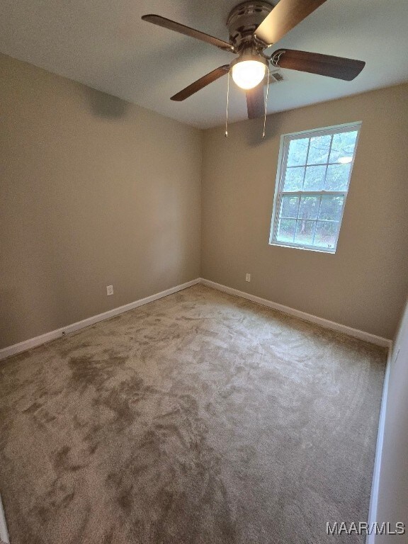 1780 Fitzpatrick Rd, Wetumpka, AL 36092 - spare room featuring carpet floors, baseboards, and ceiling fan