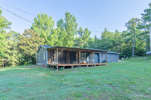 view of front of home with a front yard and a deck