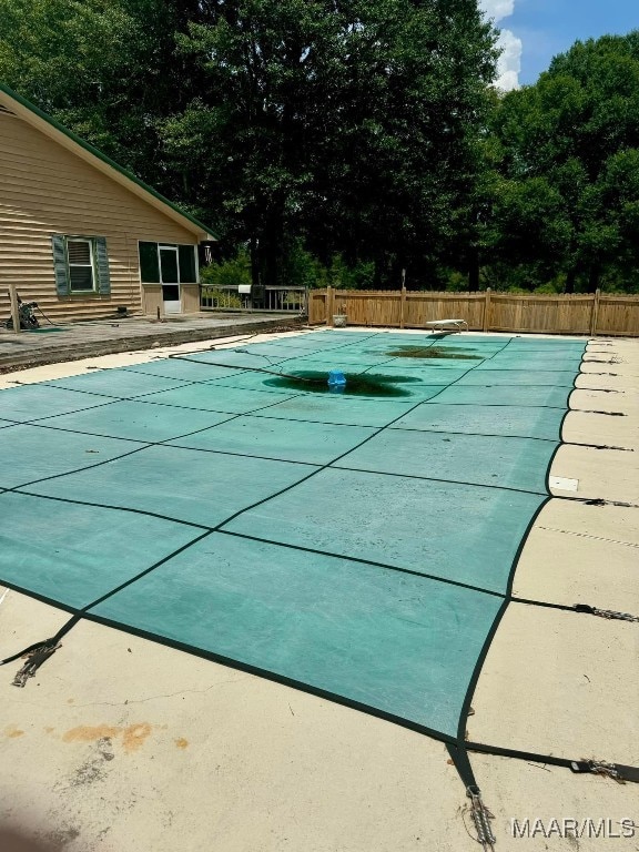 view of pool featuring a diving board