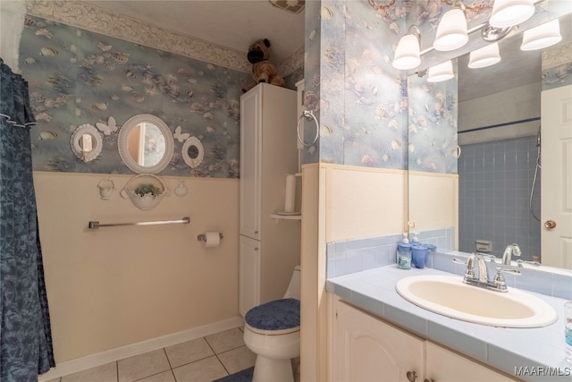 bathroom with a shower with curtain, vanity, toilet, and tile patterned floors