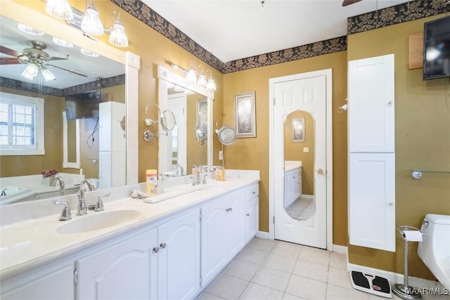full bathroom featuring a sink, tile patterned flooring, ceiling fan, and double vanity