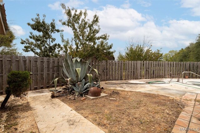 view of yard featuring a fenced in pool, a fenced backyard, and a patio area