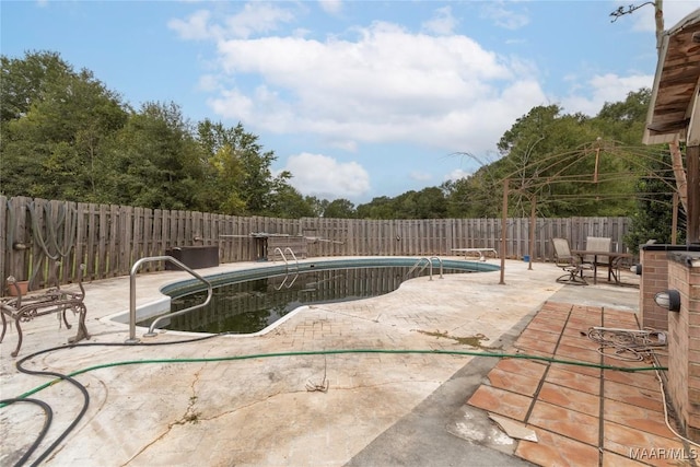 view of swimming pool with a patio, a fenced in pool, and a fenced backyard