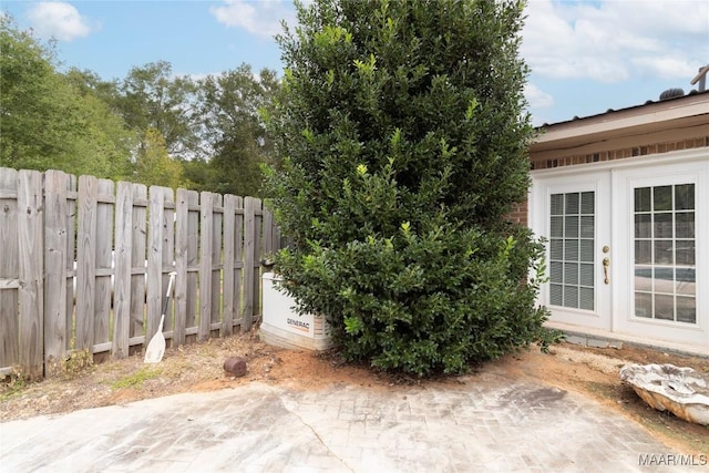 exterior space featuring french doors and fence