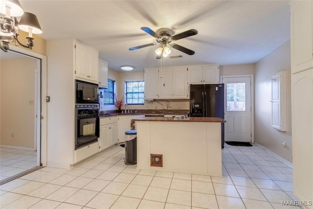 kitchen with white cabinetry, black appliances, and dark countertops