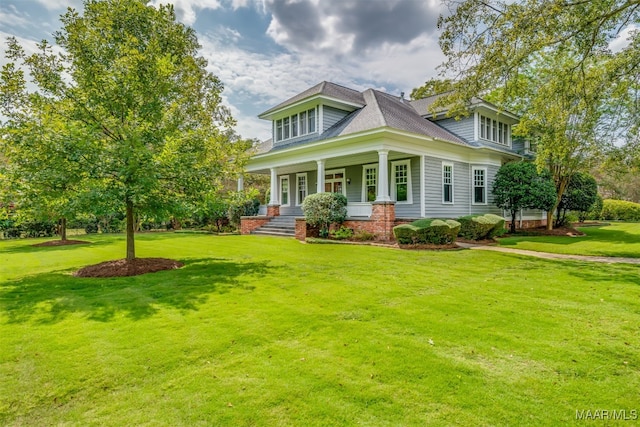 view of front of home with a porch and a front yard