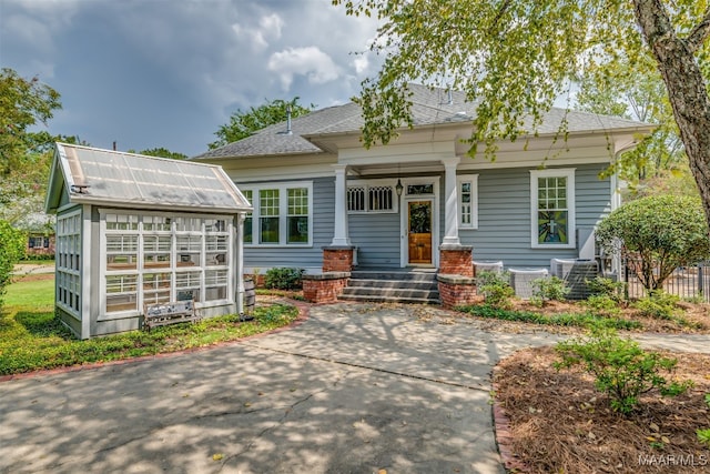 view of front of property with cooling unit and a porch