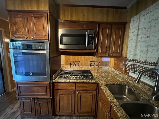 4512 Delray Rd, Montgomery, AL 36116 - kitchen featuring crown molding, dark wood-style flooring, light stone countertops, a sink, and appliances with stainless steel finishes