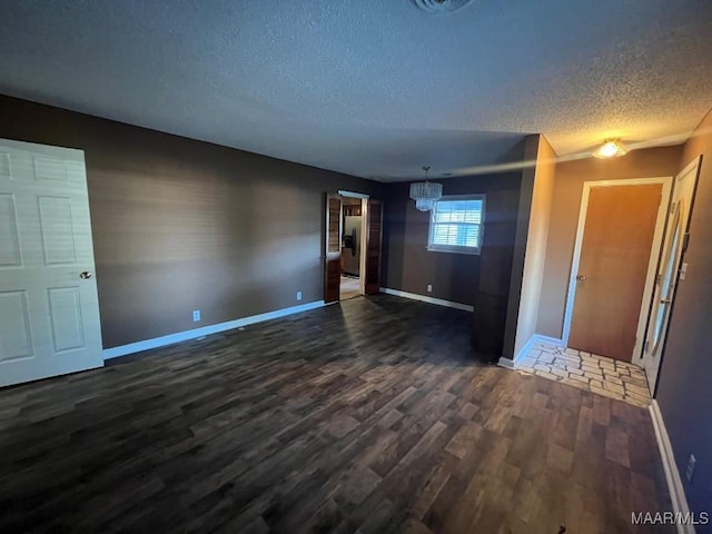 4512 Delray Rd, Montgomery, AL 36116 - spare room featuring an inviting chandelier, baseboards, dark wood finished floors, and a textured ceiling