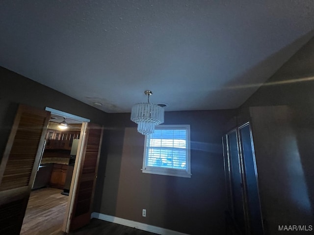 interior space with hardwood / wood-style floors and a chandelier