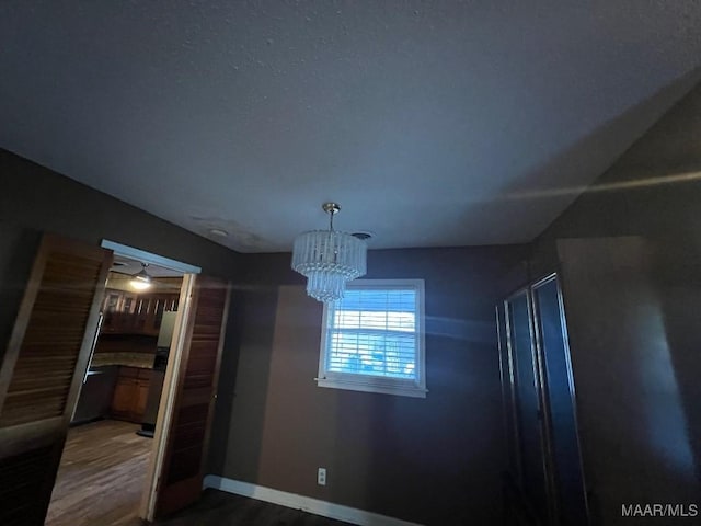 4512 Delray Rd, Montgomery, AL 36116 - unfurnished dining area with baseboards, a notable chandelier, and dark wood-type flooring