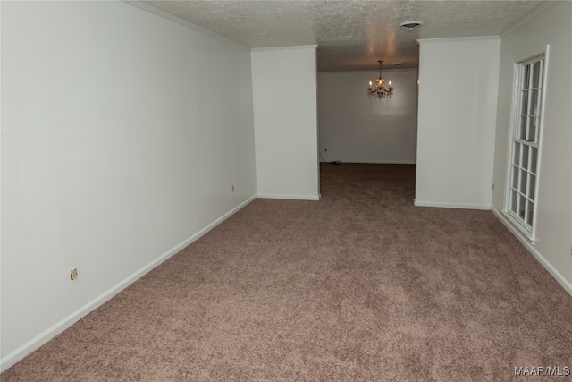 spare room featuring carpet, a chandelier, and a textured ceiling