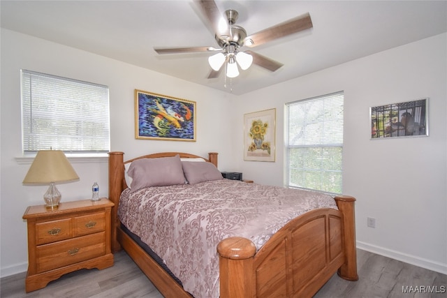 bedroom featuring light hardwood / wood-style flooring and ceiling fan