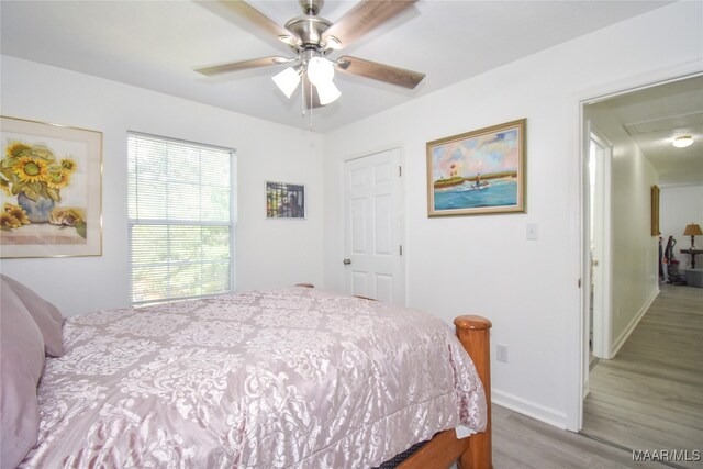 bedroom featuring ceiling fan and light hardwood / wood-style flooring