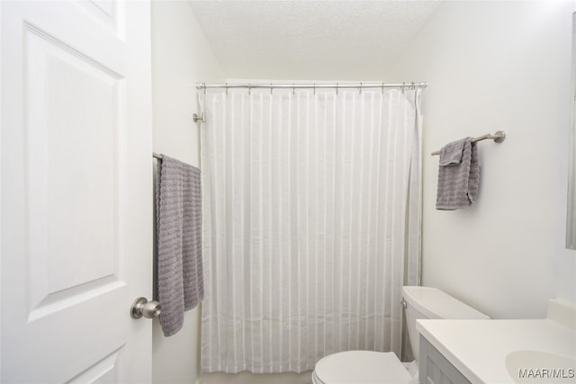 bathroom with a textured ceiling, vanity, toilet, and a shower with shower curtain