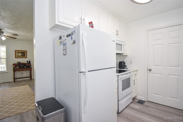 kitchen with white appliances, white cabinetry, ceiling fan, and light hardwood / wood-style flooring