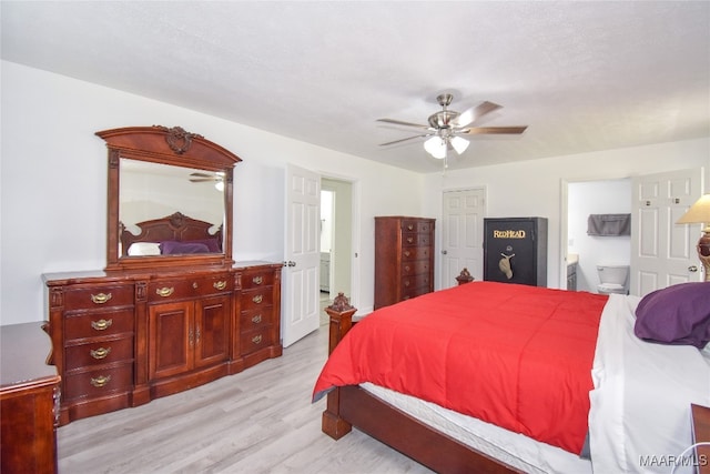 bedroom with ceiling fan, ensuite bath, and light hardwood / wood-style floors