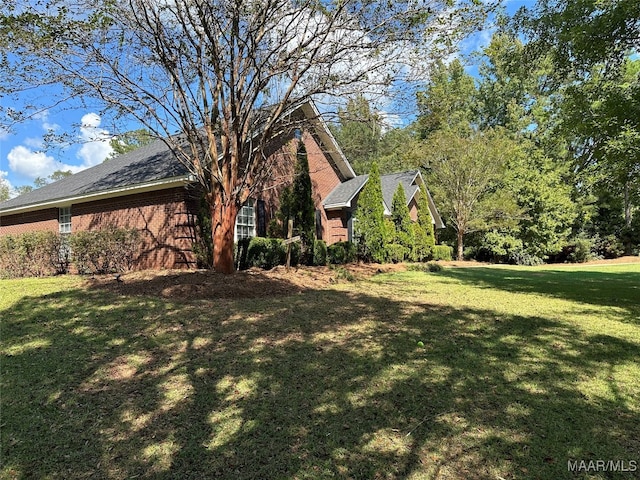 view of side of property with a yard