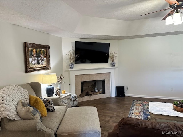 414 Warrior Dr, Valley Grande, AL 36701 - living room with wood finished floors, ceiling fan, a textured ceiling, a fireplace, and baseboards