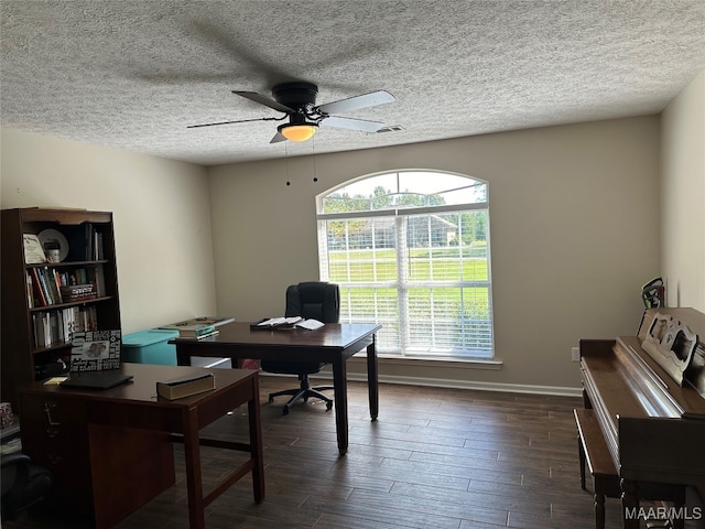 office featuring a textured ceiling, dark hardwood / wood-style flooring, and ceiling fan