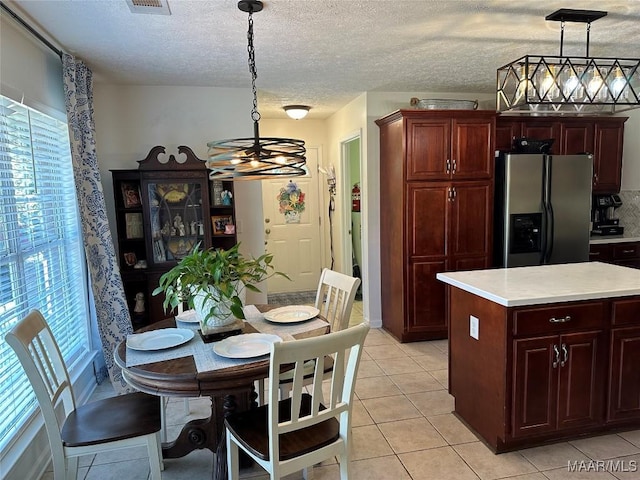 414 Warrior Dr, Valley Grande, AL 36701 - kitchen with stainless steel fridge with ice dispenser, a chandelier, light countertops, pendant lighting, and light tile patterned floors