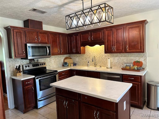 414 Warrior Dr, Valley Grande, AL 36701 - kitchen with appliances with stainless steel finishes, light countertops, light tile patterned floors, a sink, and a textured ceiling