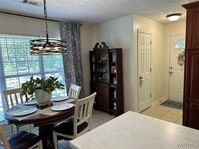 414 Warrior Dr, Valley Grande, AL 36701 - dining space with a chandelier, light tile patterned floors, and a textured ceiling