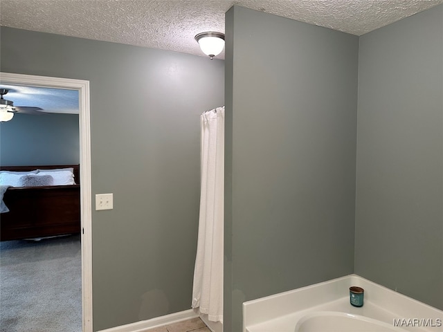 bathroom with a shower with shower curtain, a textured ceiling, and ceiling fan