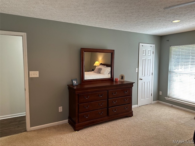 carpeted bedroom with a textured ceiling