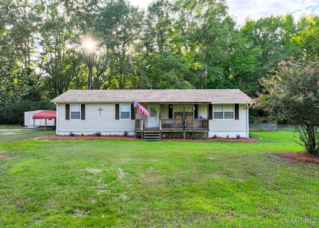 single story home featuring covered porch, a front lawn, and fence