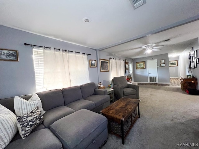 carpeted living room with visible vents and ceiling fan