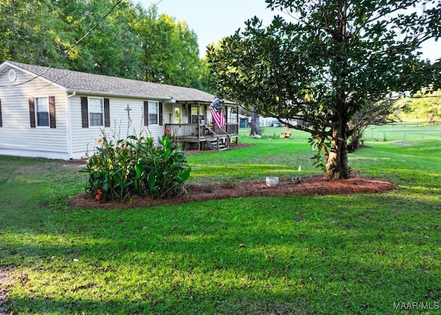 exterior space with a front yard and fence