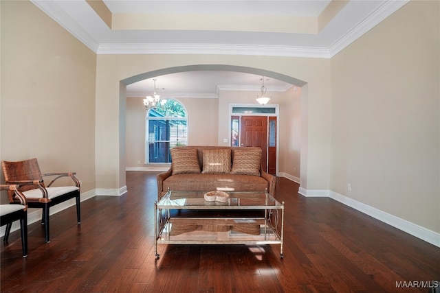 living room featuring an inviting chandelier, crown molding, and dark hardwood / wood-style flooring