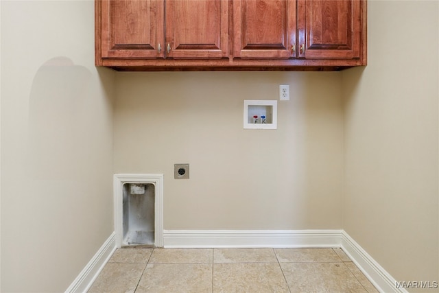 washroom featuring washer hookup, cabinets, light tile patterned floors, and hookup for an electric dryer