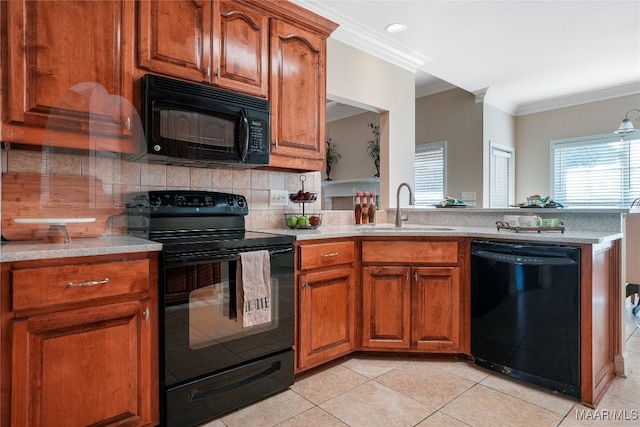 kitchen featuring tasteful backsplash, light tile patterned floors, black appliances, ornamental molding, and sink