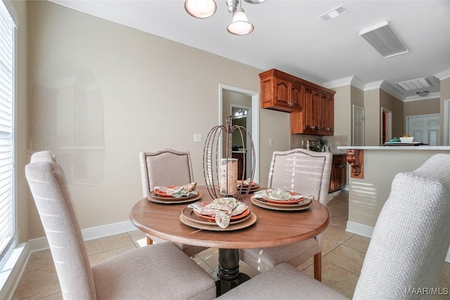 dining room featuring crown molding and light tile patterned floors