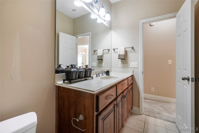 bathroom featuring vanity, toilet, and tile patterned floors